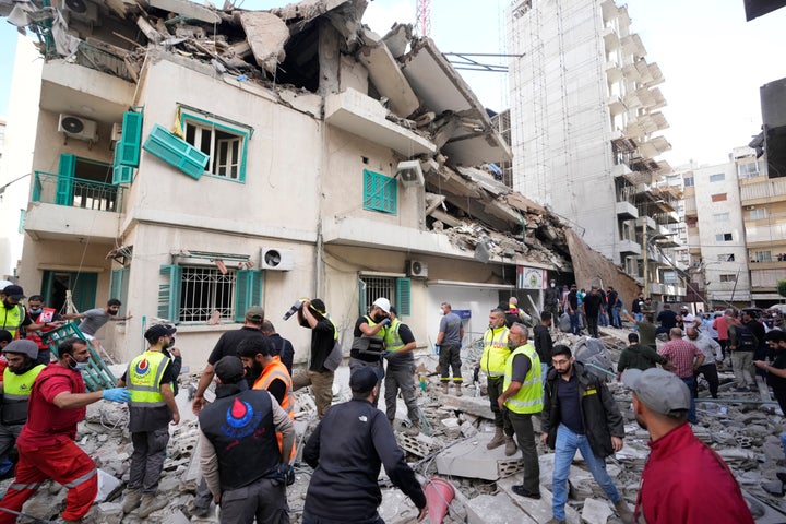 Israeli Strike In Beirut Kills Hezbollah's Spokesman, While Strike In Gaza Kills At Least 30 2 Residents and rescuers gather near a damaged building at the site of an Israeli airstrike in central Beirut's Ras el-Nabaa neighborhood, Lebanon, Sunday, Nov. 17, 2024. (AP Photo/Hassan Ammar)