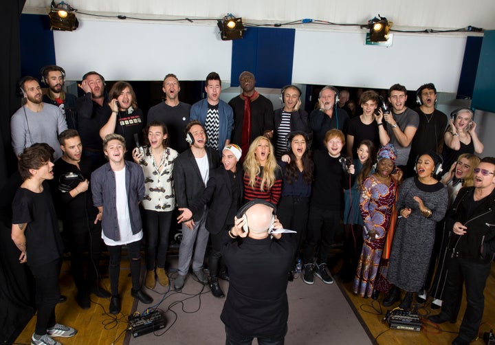 The stars of Band Aid 30, including Ed Sheeran, recording their cover of Do They Know It's Christmas? in 2014