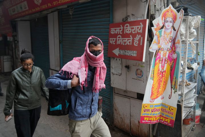 A office goer walks wearing a face mask amidst a thick layer of smog as air pollution shoots up in New Delhi, India, on Nov. 18, 2024.