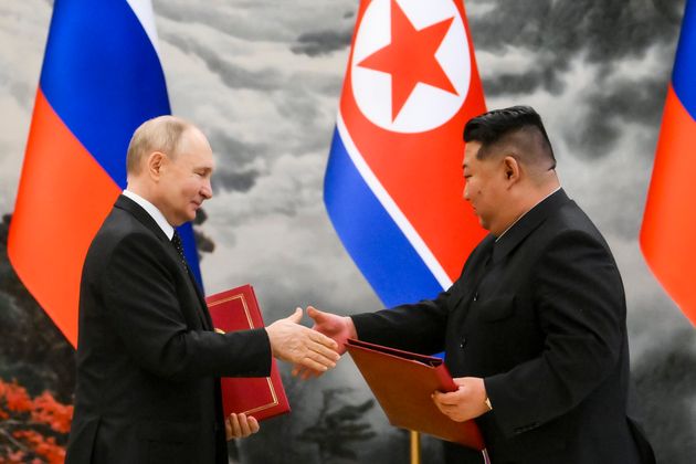 Putin, left, and North Korea's leader Kim Jong Un exchange documents during a signing ceremony of the new partnership in Pyongyang, North Korea.