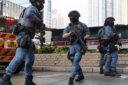Armed police officers stand guard outside the West Kowloon Magistrates' Courts in Hong Kong on Nov. 19, 2024.