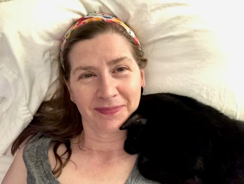 The author snuggling with a foster cat in 2021.