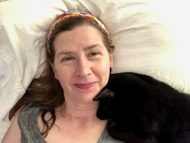 The author snuggling with a foster cat in 2021.