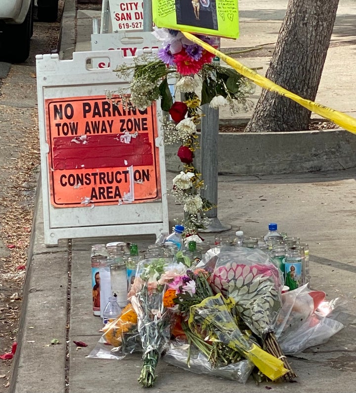 Flowers, candles, offerings of food and beverages and police tape mark the spot in San Diego where Rachael Martinez and Jose Medina were killed while sitting in their parked car.