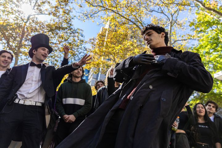 Anthony Po (left) watches a contestant perform Oct. 27 at the Timothée Chalamet look-alike contest near Washington Square Park in New York City.