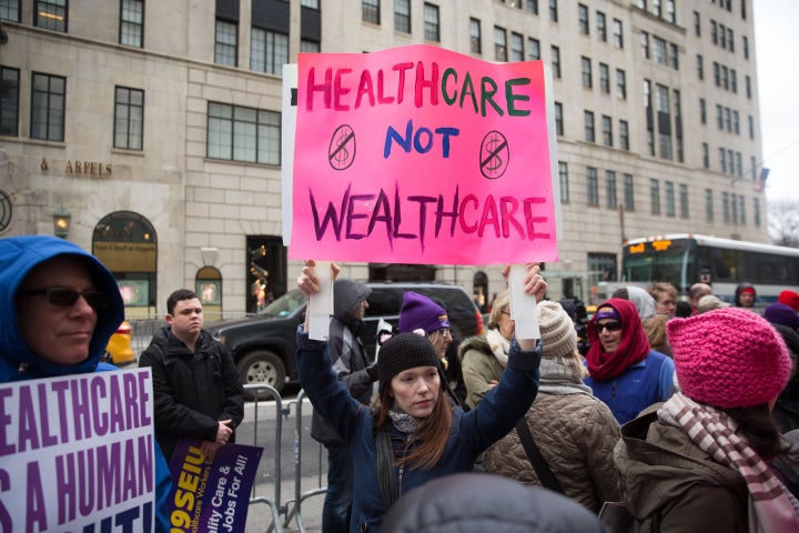 Health care activists lift signage promoting the Affordable Care Act during a rally as part of the national "March for Health" movement in front of Trump Tower on April 1, 2017, in New York City.