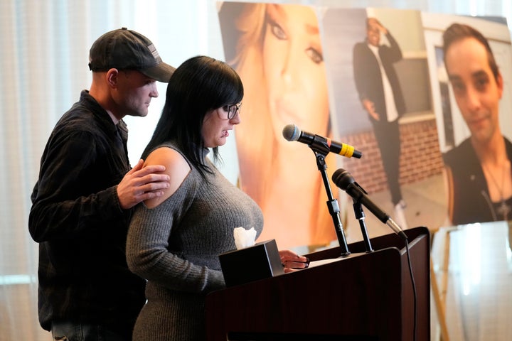 Ashtin Gamblin, survivor of the Club Q nightclub mass shooting in Colorado Springs, Colo., is consoled by her husband Robert Conner Jr., during a news conference announcing the filing of a civil complaint on the two-year anniversary of the deadly mass shooting, Tuesday, Nov. 19, 2024, in Denver. 