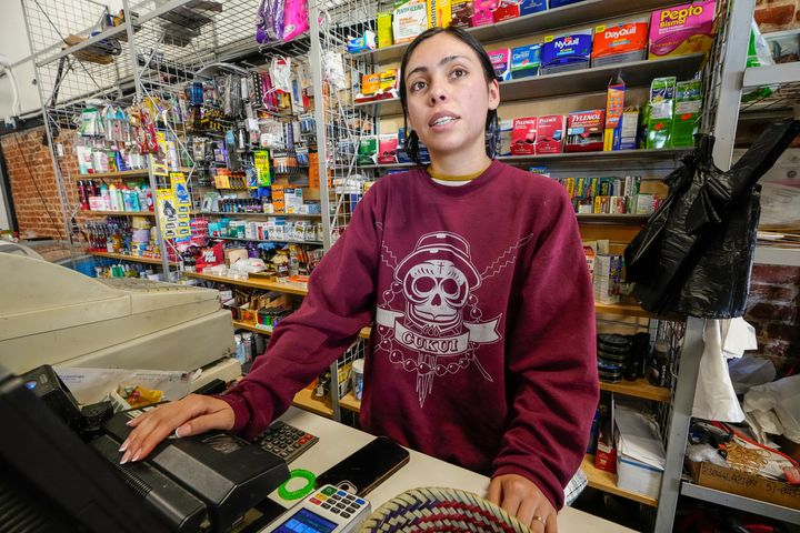 College student Jimena Sanchez, right, who studies children's development works as a part-time cashier earning minimum wage at a family store, in Los Angeles on Oct. 11, 2024. (AP Photo/Damian Dovarganes)