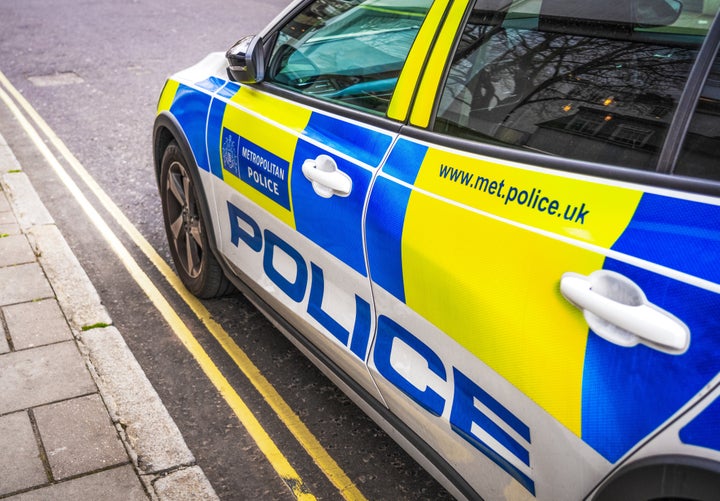 London, UK - Side view of a Met Polce car, parked on a street in central London.