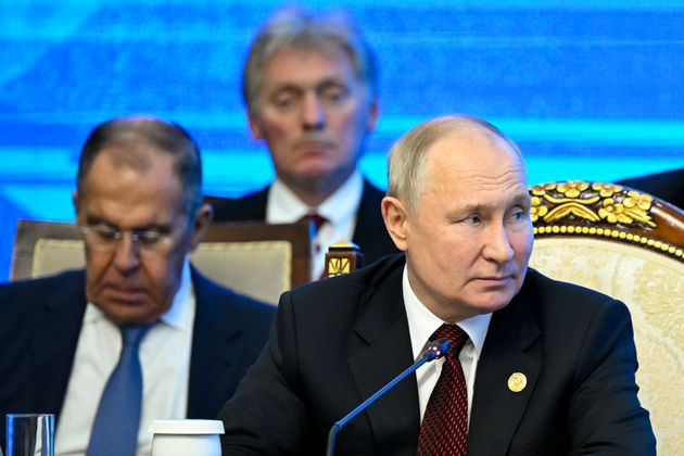 Russian President Vladimir Putin, right, Russian Foreign Minister Sergey Lavrov, left, and Kremlin spokesman Dmitry Peskov