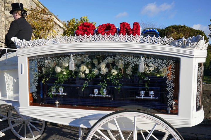 A funeral wreath at Liam Payne's memorial spells out "son"