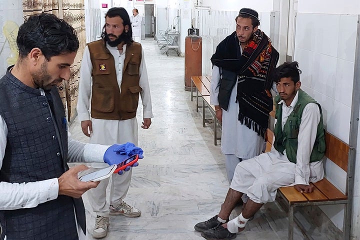 An injured victim, right, of gunmen firing incident on a passenger vehicle, is treated at a hospital in Parachinar, in Kurram district of Pakistan's northwestern Khyber Pakhtunkhwa province, Thursday, Nov. 21, 2024. (AP Photo/Dilawar Hussain)