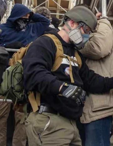 Jan. 6 rioter Edward Kelley of Tennessee, pictured here with helmet and gas mask and standing on scaffolding at the Capitol on Jan. 6, 2021.