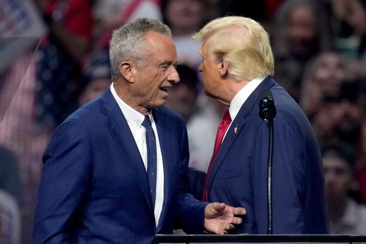 Independent presidential candidate Robert F. Kennedy Jr., left, walks to speak at a campaign rally for Republican presidential nominee former President Donald Trump, right, Friday, Aug. 23, 2024, in Glendale, Ariz. 