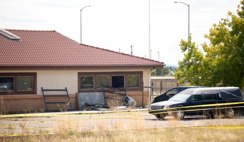 A hearse and van sit outside a closed funeral home where 115 bodies are being stored, Friday, Oct. 6, 2023, in Penrose, Colo. (AP Photo/David Zalubowski, File)