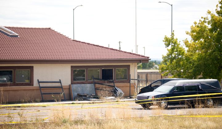 A hearse and van sit outside a closed funeral home where 115 bodies are being stored, Friday, Oct. 6, 2023, in Penrose, Colo. (AP Photo/David Zalubowski, File)