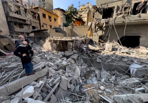 Residents observe the site of an Israeli airstrike that hit central Beirut, Lebanon, Saturday, Nov. 23, 2024. (AP Photo/Hussein Malla)
