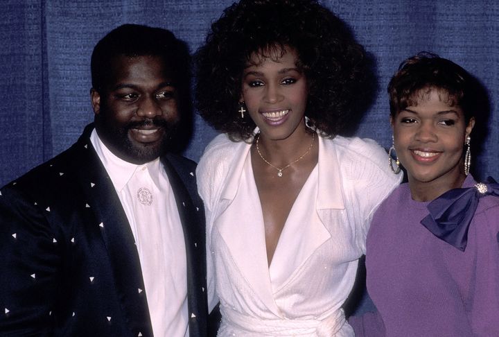 Singer BeBe Winans, singer Whitney Houston and singer CeCe Winans attend an awards dinner in 1990.