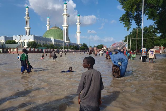 Extreme weather: People walk through floodwaters following a dam collapse in Maiduguri, Nigeria, Tuesday, Sept 10, 2024.