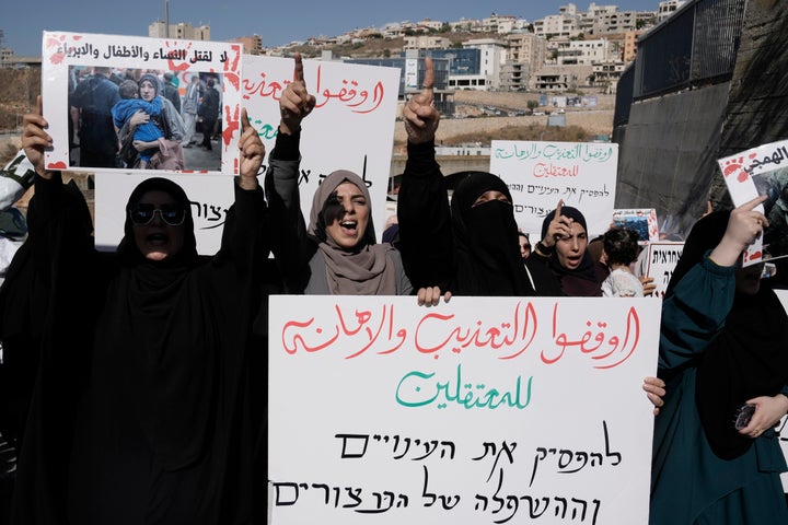 Palestinian women who are citizens of Israel march in support of those in Gaza and those detained in Israeli jails, in Umm Al-Fahm, Israel, Saturday, Aug. 3, 2024. The large sign in front reads, in Arabic: "Stop the torture and abuse of detainees."