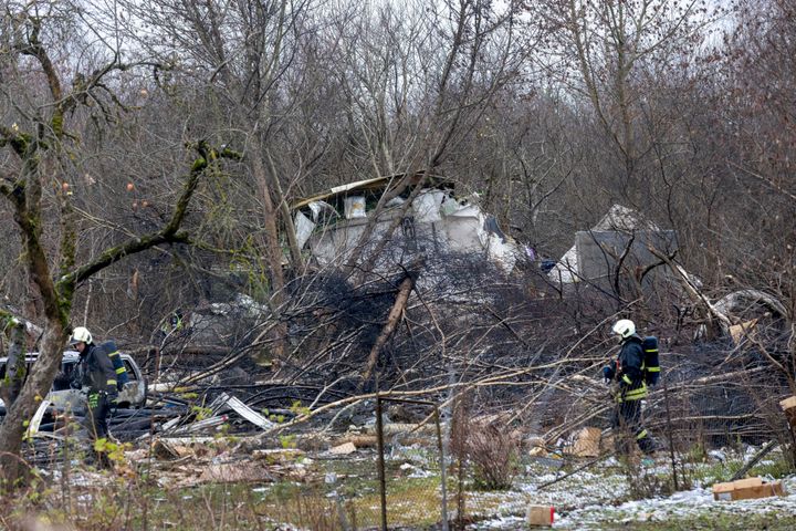 Lithuanian Emergency Ministry employees work near the site where a DHL cargo plane crashed into a house near the Lithuanian capital Vilnius, Lithuania, Lithuania, on Nov. 25, 2024.