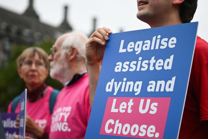 A campaigner from "Dignity in Dying" holds a placard during a demonstration outside parliament last month.