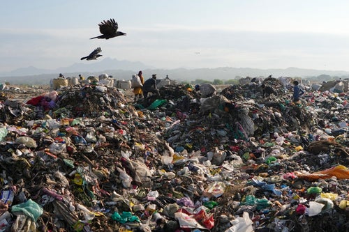 Indian rag pickers look for reusable material at a garbage dump filled with plastic and other waste material on the outskirts of Jammu, India, April 22, 2024.