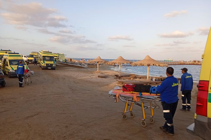 Rescuers wait on the beach of Marsa Alam, Egypt, on Monday.