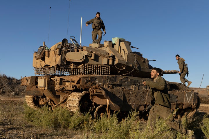 Israeli soldiers stand near a tank as it is moving along the Israeli-Lebanese border on Nov. 26, 2024. Israeli Prime Minister Benjamin Netanyahu said he supports a proposed 60-day ceasefire deal with Hezbollah, the Lebanese militant group whom Israel launched a ground invasion against nearly two months ago.