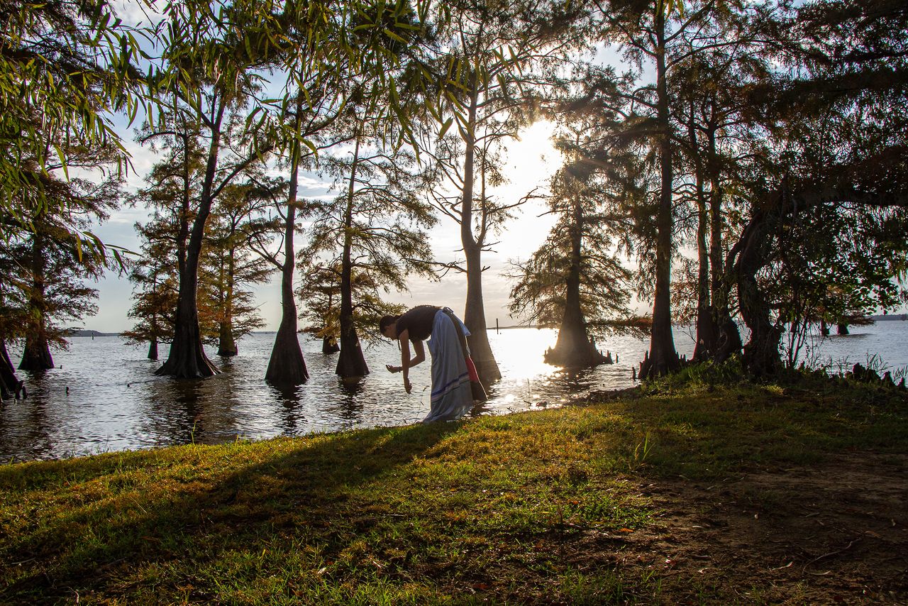 Joe Whittle’s daughter, River Whittle, gathers plant medicines on the shores of Caddo Lake, which sits on the border of Northeast Texas and Northwest Louisiana. Caddo creation stories state that Caddo people first emerged from the earth near Caddo Lake. It has been said that when Caddo people were forcibly removed from their homelands in Louisiana during the Trail of Tears era, many Caddos chose to walk into Caddo Lake and reunite with their ancestors by drowning themselves, rather than leave their beloved homeland. Whittle’s great-great-grandfather survived the Trail of Tears as a child, but his infant brother did not.