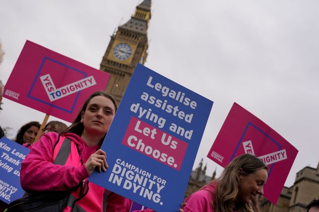 Assisted dying advocates hold a protest outside the Hoses of Parliament as a bill to legalise assisted dying is to be put before lawmakers on Friday, 29 November.