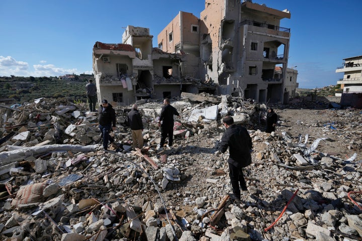 Residents check their destroyed houses after they returned to Qana village, southern Lebanon, Thursday, Nov. 28, 2024 following a ceasefire between Israel and Hezbollah that went into effect on Wednesday. (AP Photo/Hussein Malla)