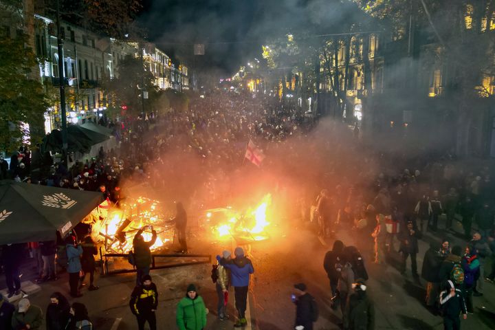 Protesters pour into the streets and put fire following Georgian Prime Minister Irakli Kobakhidze's announcement, rallying outside the parliament building in Tbilisi, Georgia, on Nov. 29, 2024. 