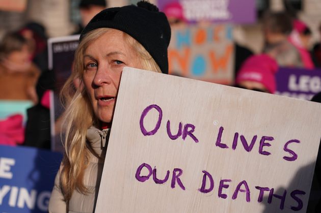 Pro legal assisted dying supporters demonstrate in front of Parliament in London, Friday, Nov. 29, 2024.