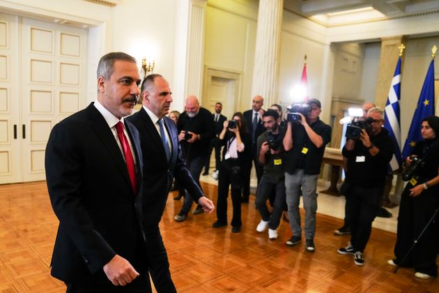 Greek Foreign Minister George Gerapetritis, and his Turkish counterpart Hakan Fidan, left, walk at the Greek Foreign Ministry during their meeting in Athens, Greece, Friday, Nov. 8, 2024. (AP Photo/Thanassis Stavrakis)