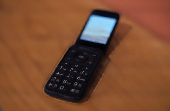 A photo shows the author's TCL flip phone.