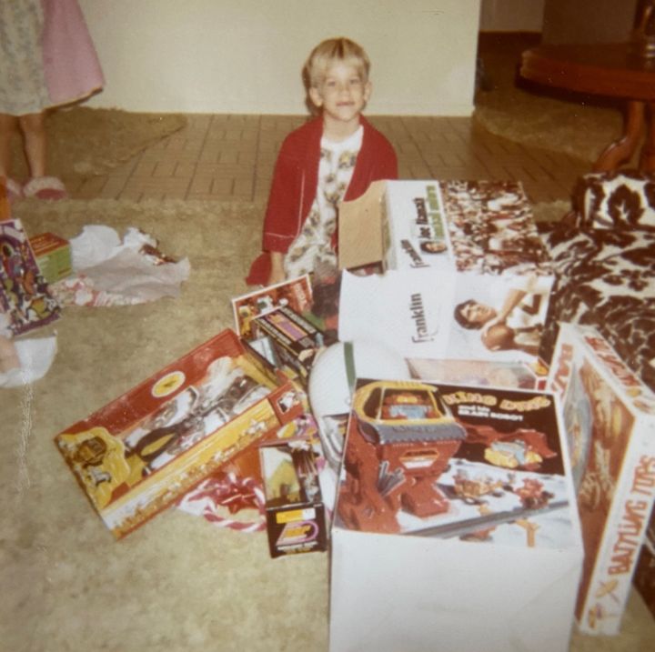 The author, age 6, is photographed on Christmas in 1971. "The Joe Namath uniform did NOT land as effectively as the castle set," the author writes.