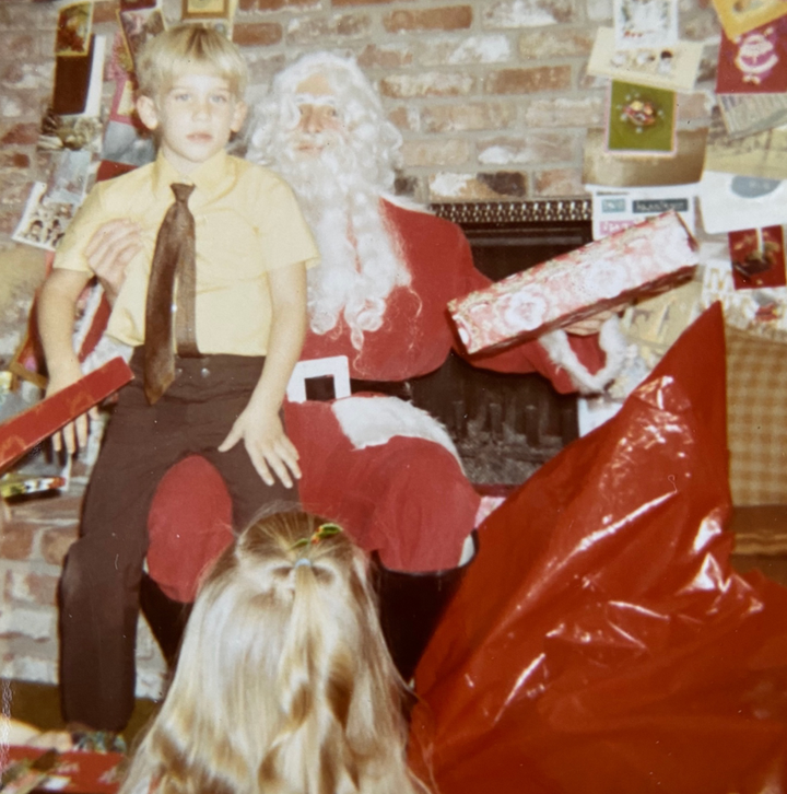 The author is seen at age 7 with Santa, played by an uncle named Danny, in December 1972.