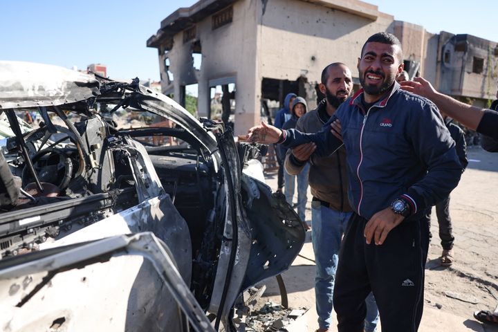 People react in front of a car hit by an Israeli strike in Khan Yunis in the southern Gaza Strip on November 30, 2024, in which five people were reported killed, including three World Central Kitchen (WCK) workers, according to a report by the civil defence in the Palestinian territory. The Israeli army said in a statement that it had carried out a strike on "a vehicle transporting a terrorist who participated in the October 7 massacres", adding that "the assertion that the terrorist was travelling among workers of the WCK is under investigation." (Photo by BASHAR TALEB / AFP) (Photo by BASHAR TALEB/AFP via Getty Images)