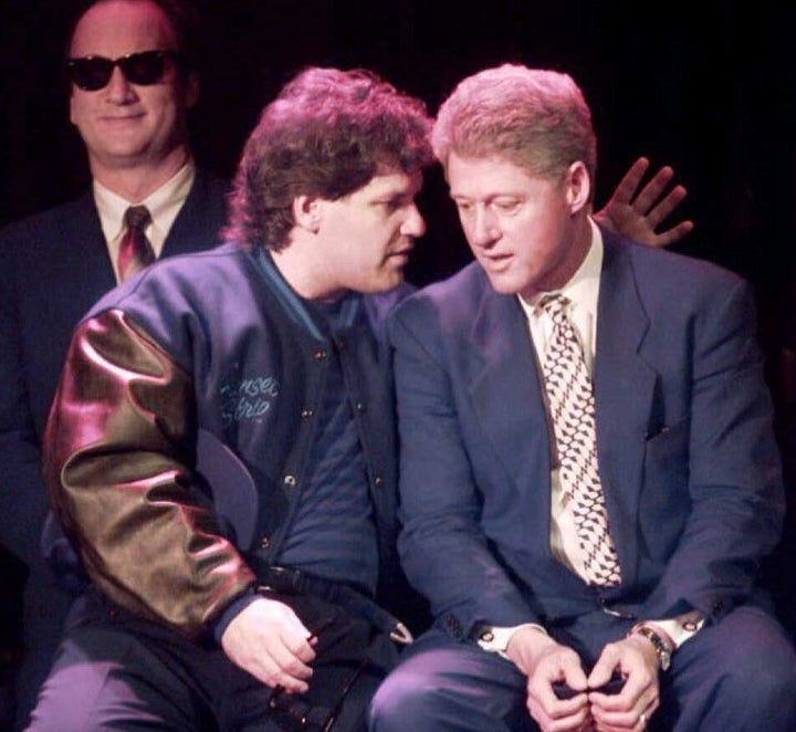 Then-President Bill Clinton is seen with his half-brother, Roger Clinton, during a political fundraiser that was attended by actor Jim Belushi, seen far left, in 1995.