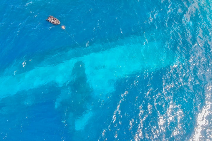 New Zealand Navy Ship Sank After Crew Accidentally Left It On Autopilot 2 In this photo provided by the New Zealand Defence Force, divers survey the area around HMNZS Manawanui on the southern coast of Upulo, Samoa, after the Manawanui ran aground and sank on Oct. 6. (AC Jese Somerville/New Zealand Defence Force via AP,File)