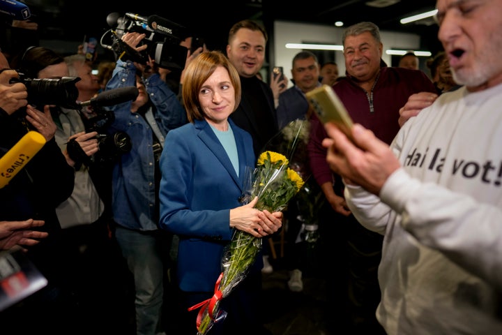 Moldova's President Maia Sandu celebrates with supporters as preliminary results are announced for the presidential election runoff in Chisinau, Moldova, Sunday, Nov. 3, 2024.