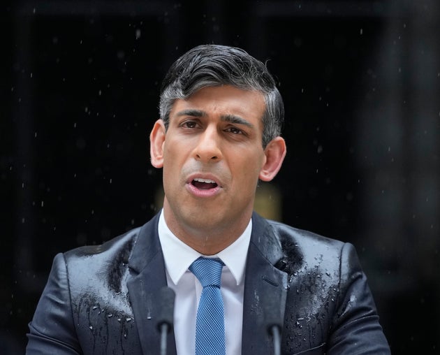 Britain's Prime Minister Rishi Sunak speaks to the media as heavy rain falls, outside 10 Downing Street in London Wednesday, May 22, 2024.