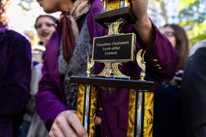 Miles Mitchell, 21, winner of the Timothee Chalamet lookalike contest, holds his trophy near Washington Square Park, Sunday, Oct. 27, 2024, in New York.