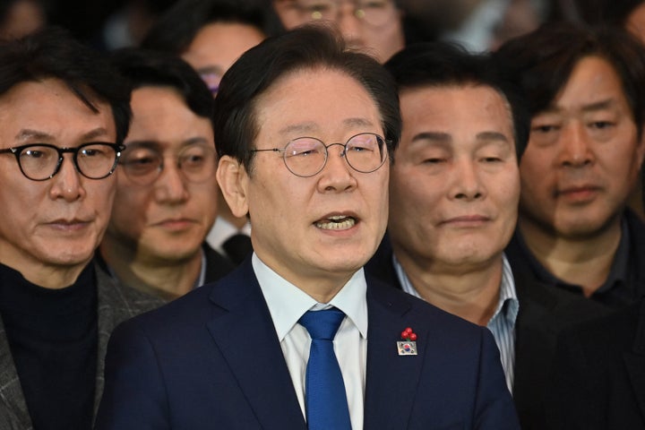 South Korea's main opposition Democratic Party leader Lee Jae-myung (center) speaks to the media at the National Assembly in Seoul on Wednesday after South Korea President Yoon Suk Yeol declared martial law.