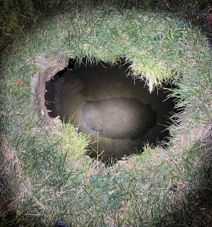 This image provided by the Pennsylvania State Police on Dec. 3, 2024, shows the top of a sinkhole in the village of Marguerite, Pa., where rescuers were searching for a woman who disappeared.