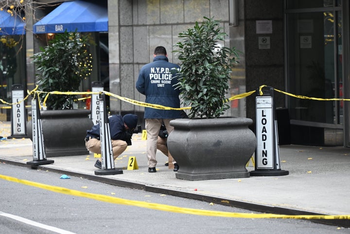 Police officers investigate the scene where UnitedHealthcare CEO Brian Thompson was fatally shot in Midtown Manhattan.