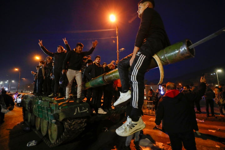 Syrians celebrate the arrival of opposition fighters in Damascus, Syria, Sunday, Dec. 8, 2024. (AP Photo/Omar Sanadiki)