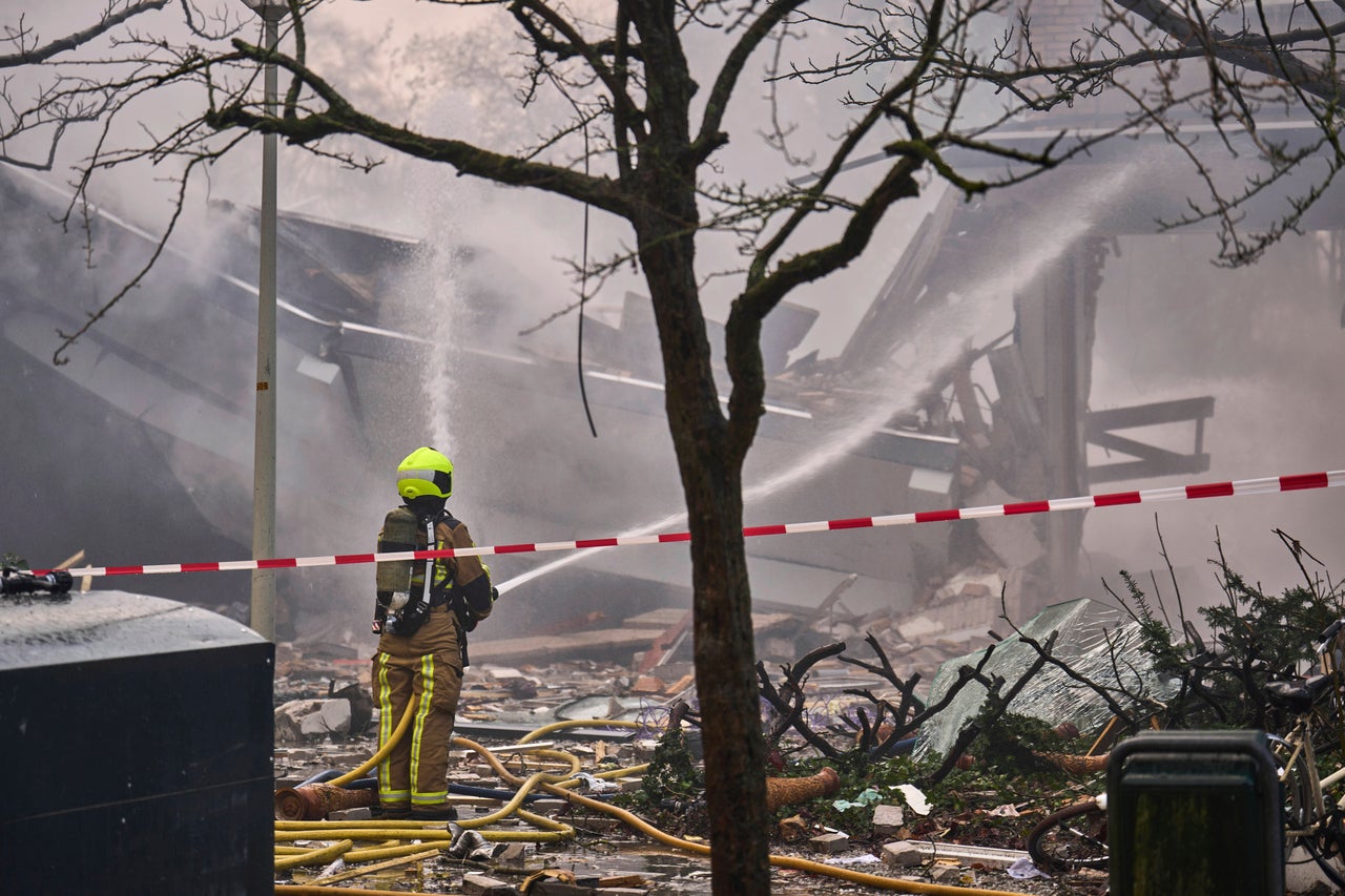 A firefighter works at the sight of an explosion at an apartment block in The Hague, Saturday, Dec. 7, 2024. (AP Photo/Phil Nijhuis)