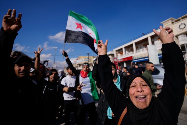 Syrians celebrate the fall of Syrian President Bashar Assad's government in the town of Bar Elias, Lebanon, near the border with Syria, Sunday, Dec. 8.